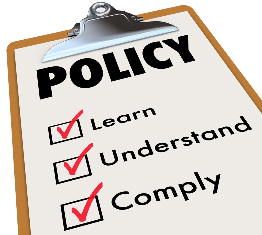 Policy word on a checklist clipboard for rules, regulations or laws with check boxes for learn, understand and comply.